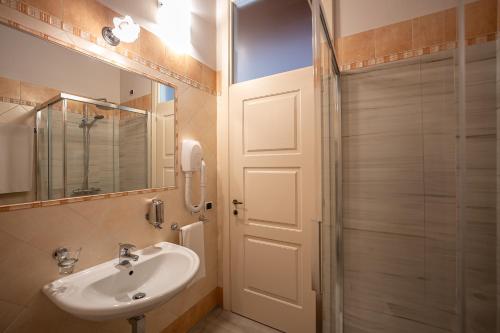 a bathroom with a white sink and a shower at Villa Bongiovanni in San Bonifacio