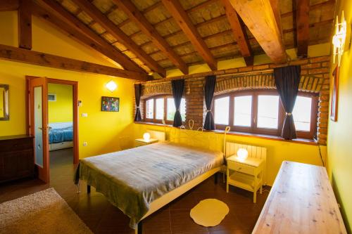 a bedroom with a large bed and a wooden ceiling at The Shire in Poljane