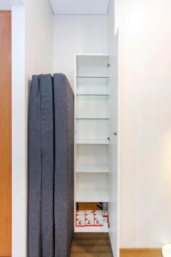 a closet with a surfboard in a room at Perth Central CBD convenience! in Perth