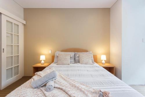 a bedroom with a large bed with two lamps at Perth Central CBD convenience! in Perth
