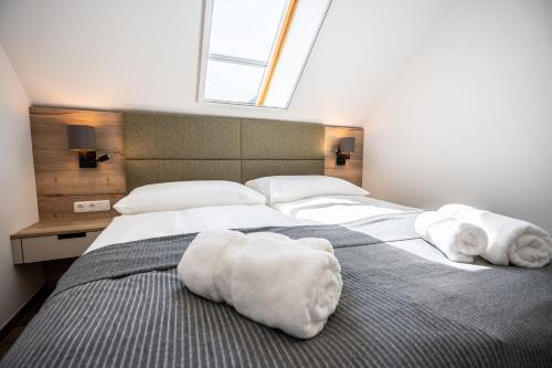 a bedroom with a large bed with towels on it at Schloss Hantberg Apartments 