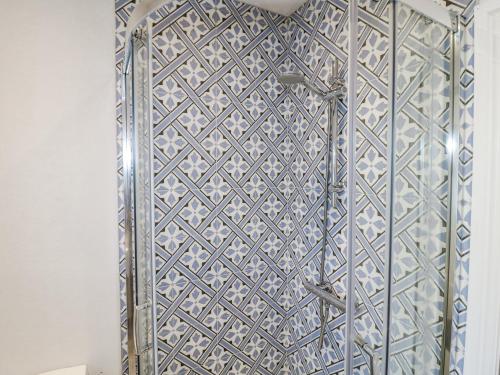 a glass shower door with a geometric pattern on it at The View Orchard View in Ashbourne