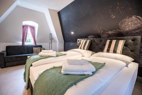two beds with towels on them in a room at Schloss Hantberg Apartments 