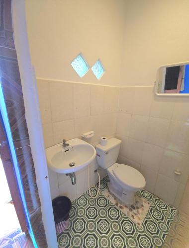 a bathroom with a toilet and a sink at Khmer House Guesthouse in Kep