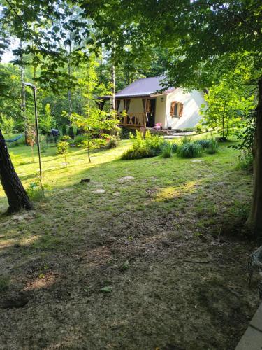 a white tent in the middle of a yard at Hacienda domek całoroczny z jacuzzi w lesie pod Rzeszowem in Strzyżów