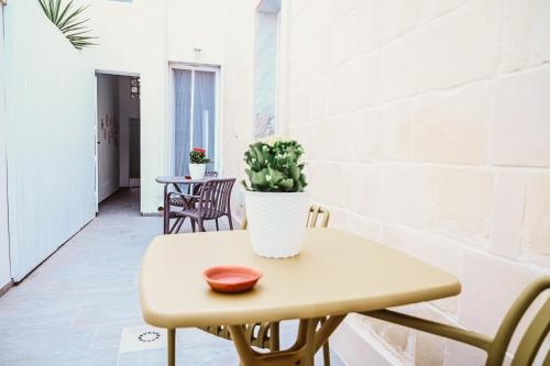a small table with a potted plant on it at Sami Twin Suite in Lecce