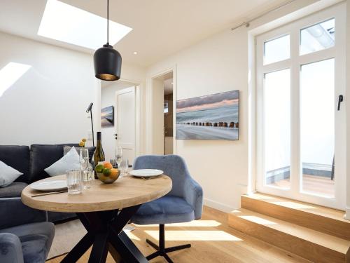 a living room with a table and a couch at Appartement Carla in Westerland (Sylt)