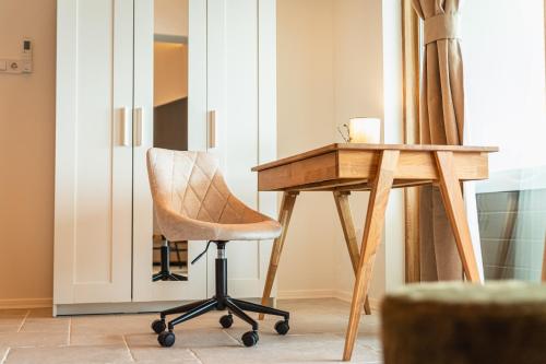 a wooden desk and a chair next to a table at Villa Mianka Rab in Banjol