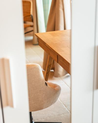 a chair sitting next to a wooden table at Villa Mianka Rab in Banjol