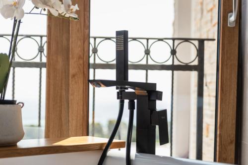 a camera on a stand in front of a window at Villa Mianka Rab in Banjol