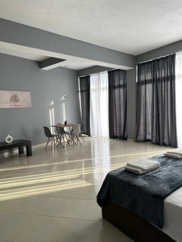 a bedroom with a bed and a table and chairs at Freske Rooms in Krujë