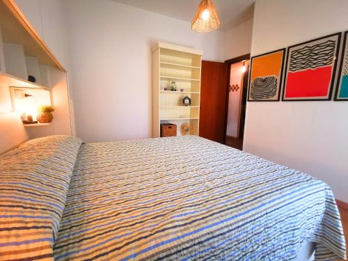 a bedroom with a large bed in a room at Appartament Sunrise 150mt from the beach in Alba Adriatica