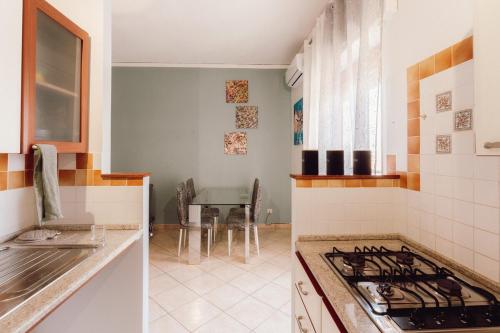 a kitchen with a sink and a stove top oven at Locri Beautiful Modern Three-Room Apartment in Locri