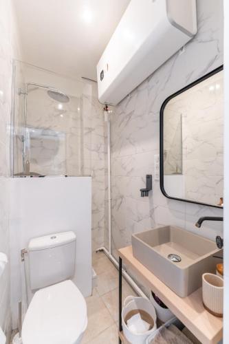 une salle de bain avec des toilettes blanches et un lavabo dans l'établissement Le Miradou-T2-Confort Panier & Vieux-port, à Marseille