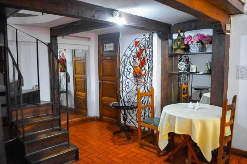 a dining room with a table and chairs and a window at Hotel Regidor in Salta