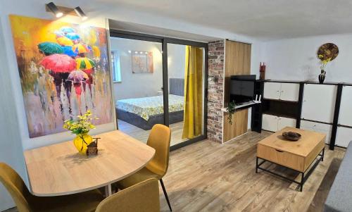 a living room with a table and a bedroom at Old-Timer 2 Central Varna in Varna City