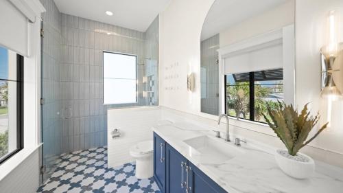 a bathroom with a sink and a toilet at Salty Sunrise in Clearwater Beach