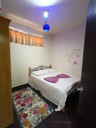 a bedroom with a bed and a rug on the floor at Porto Matrouh Chalet شاليه بورتو مطروح in Marsa Matruh