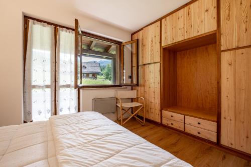 Postel nebo postele na pokoji v ubytování Un respiro nel bosco - Residence Cèsa Da Mont