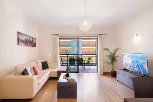 a living room with a couch and a table at MyOasis II - Algarve in Olhão
