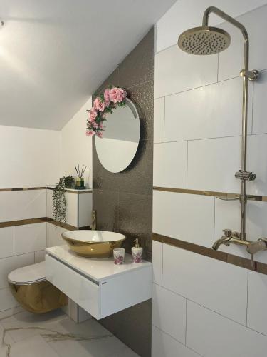 a bathroom with a sink and a mirror at Apartments Villa Dalmatina in Vodice