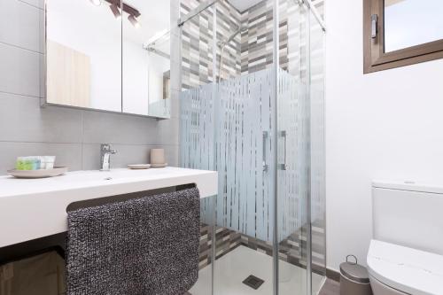 a bathroom with a sink and a shower at 60 Pueblo Majorero in El Cortijo de Tetuí