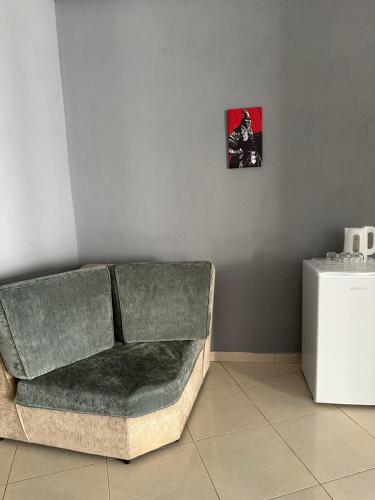 a couch in a room with a picture on the wall at Freske Rooms in Krujë