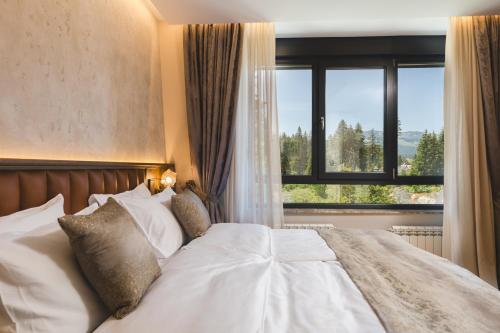 Un ou plusieurs lits dans un hébergement de l'établissement Hotel Rezident