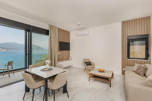 a living room with a couch and a table at Njivice Coastal Oasis in Njivice