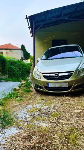 a white car is parked in a garage at Erato's Nest - Pelion in Pilion