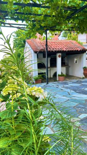 a small white house with a red roof at Erato's Nest - Pelion in Pilion