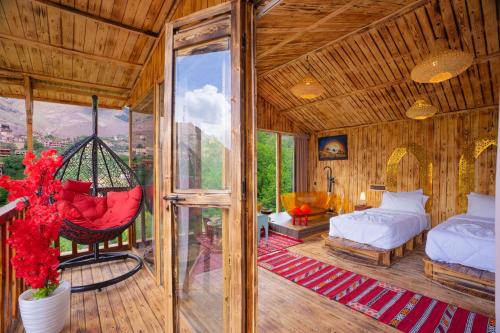 a bedroom with a hammock in a room at Riad Atlas Bangalow in Imlil