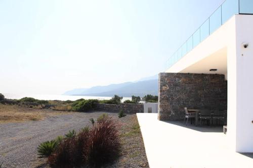 a white house with a view of the ocean at Astrokastro Seaside Residence in Frangokastello