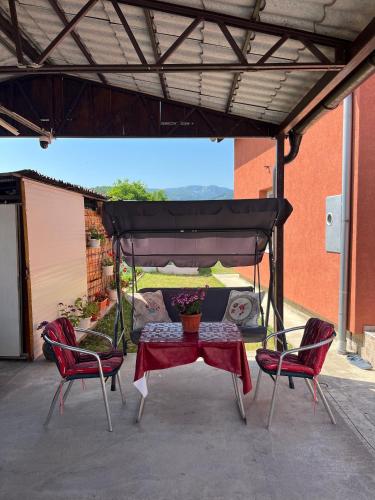 a patio with a table and chairs under a canopy at Apartman CVET Bajina Bašta in Bajina Bašta