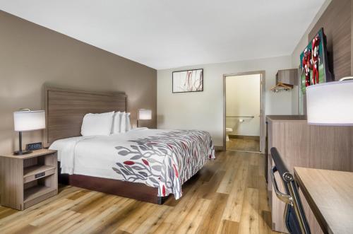 a hotel room with a bed and a desk at Red Roof Inn Staunton in Staunton