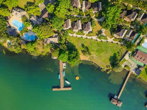 an aerial view of a lake with a dock at Banana Palms Hotel in Rio Dulce