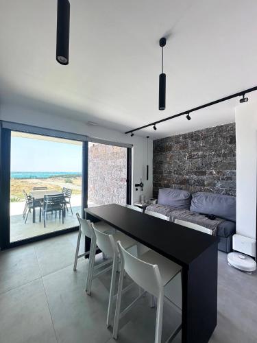 a living room with a black table and chairs at Astrokastro Seaside Residence in Frangokastello