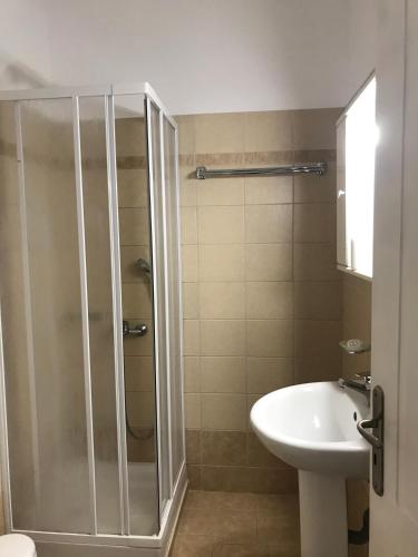 a bathroom with a shower and a toilet and a sink at Paradisos in Áyioi Pándes