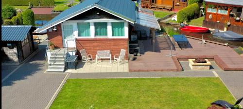 an aerial view of a house with a deck and a fire pit at Kleines Paradies an der Nordsee am Großen Meer in Südbrookmerland