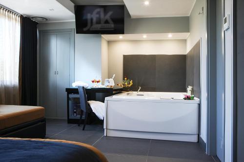a bathroom with a white sink and a desk at Best Western JFK Hotel in Naples