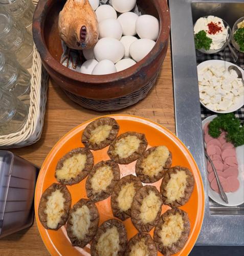 a plate of eggs on a table with a bowl of eggs at Lentävä Kalakukko -Veturi B&B in Kuopio