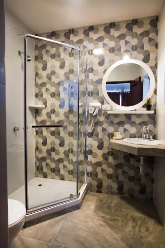 a bathroom with a shower and a toilet and a mirror at Conde de Lemos Arequipa in Arequipa