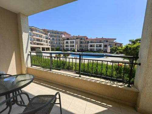 a balcony with a view of a pool and buildings at Sea Dreams Studio in Sveti Vlas