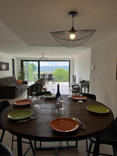 - une table à manger avec des assiettes et des verres à vin dans l'établissement La villa du Clos, à Saint-Paul-de-Vence