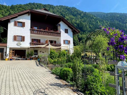 a large white building with a balcony on a mountain at Landhaus Marmorata FeWo in Sattendorf