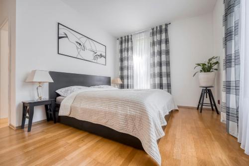 a bedroom with a bed and a wooden floor at Apartment with garden in Prague 6 in Prague