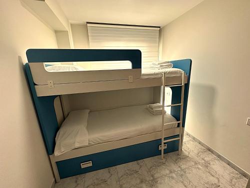 a small bunk bed in a small room at Apartamento Welcome Grañamar in Sanxenxo