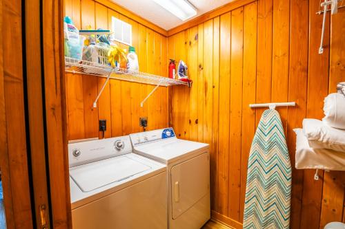 a washer and dryer in a room with wooden walls at Highlands Escape with Views 5 Min to Downtown in Highlands