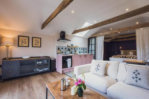 a living room with a white couch and a table at The Barrington Boar in Ilminster