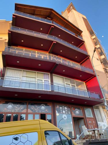 a yellow car parked in front of a building at Freske Rooms in Krujë